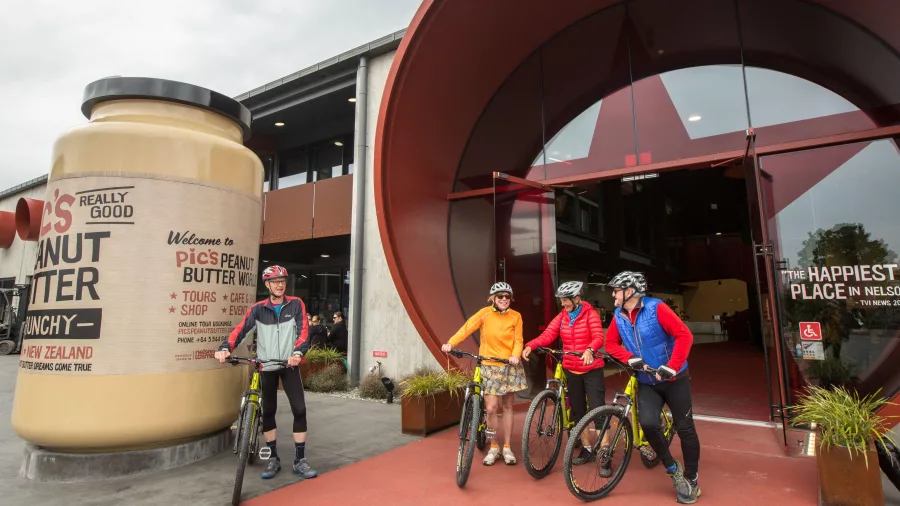 Cyclists outside Pic’s Peanut Butter World on the Great Taste Trail in Nelson