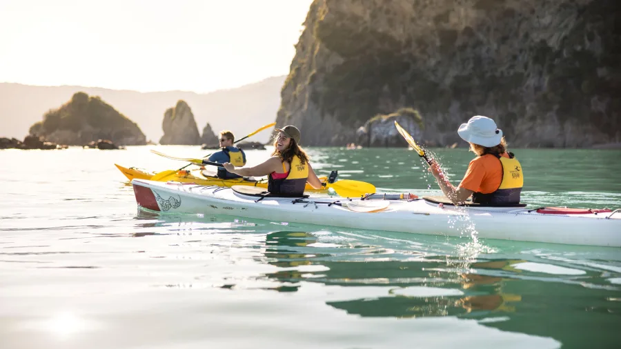 Kayakers enjoying a guided tour through sea stacks in Golden Bay