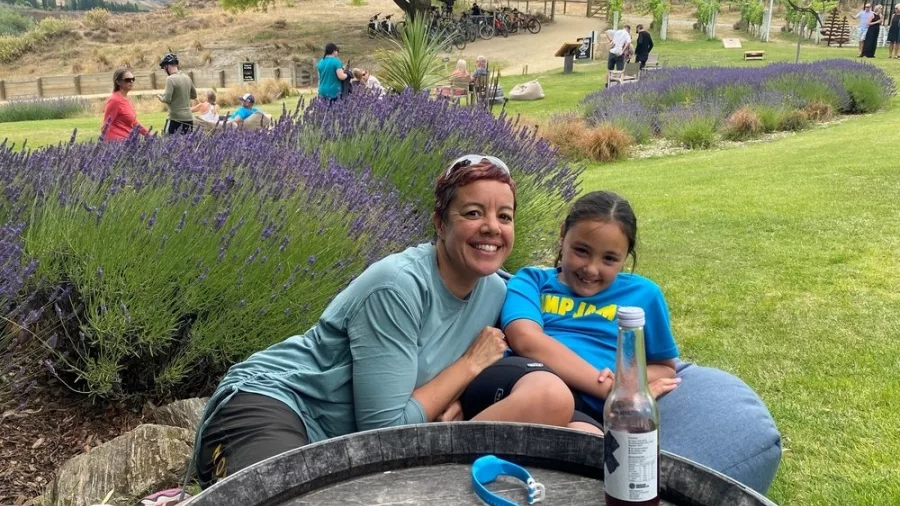 Mother and daughter relaxing on bean bags beside lavender plants in Bannockburn winery garden