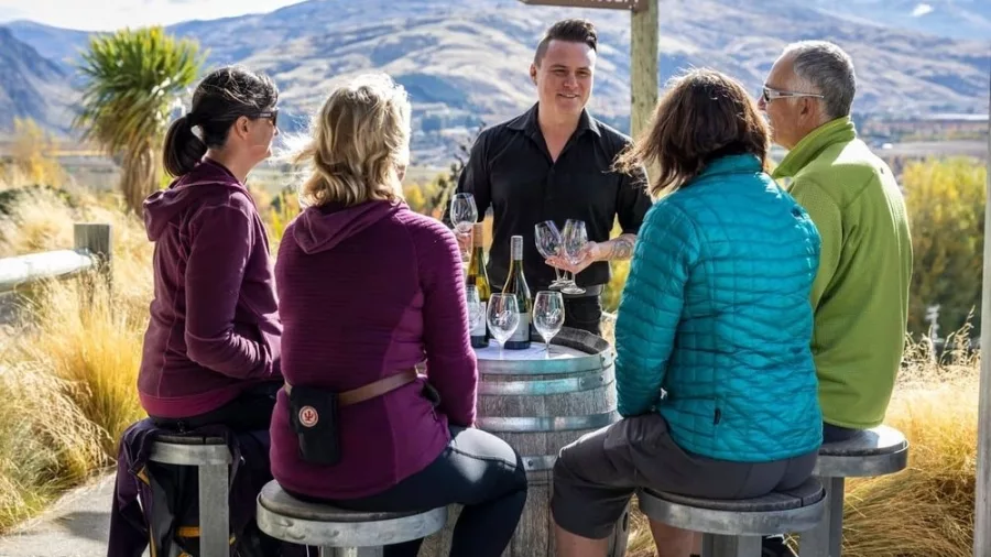 Group enjoying a wine tasting session at Mt Difficulty in Bannockburn, Central Otago
