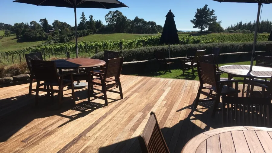 Outdoor seating on the deck overlooking vineyard rows at Moutere Hills Winery