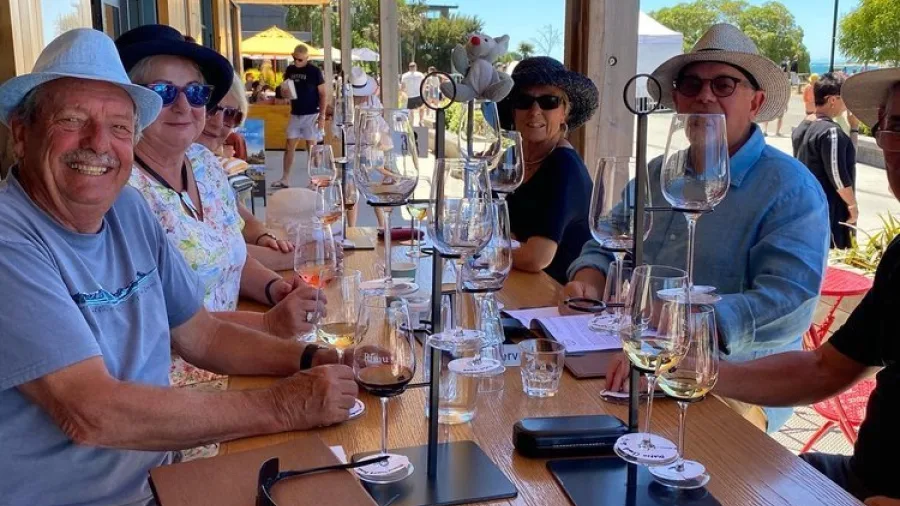 Group enjoying a wine tasting flight at Moutere Hills Winery near Kaiteriteri Beach