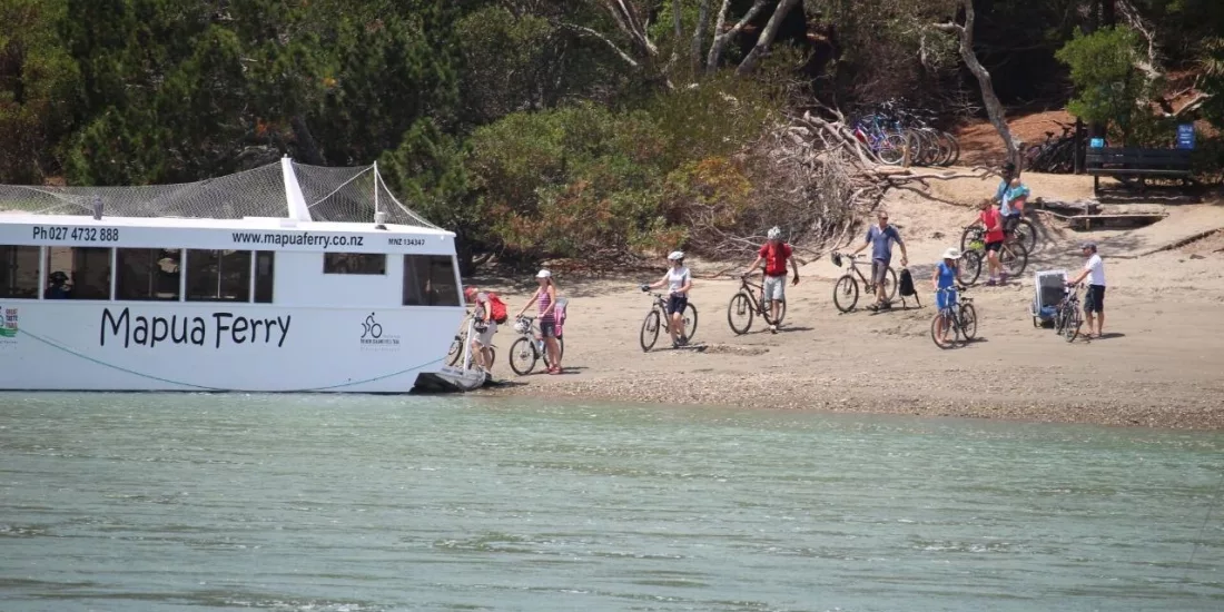 Cyclists boarding the Mapua Ferry with bikes along the Great Taste Trail in Nelson, New Zealand