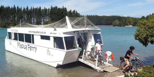 Cyclists disembarking Mapua Ferry on Magical Mapua self-guided tour