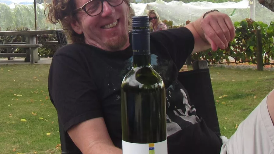 Cyclist relaxing with Neudorf wine on Moutere E-bike tour