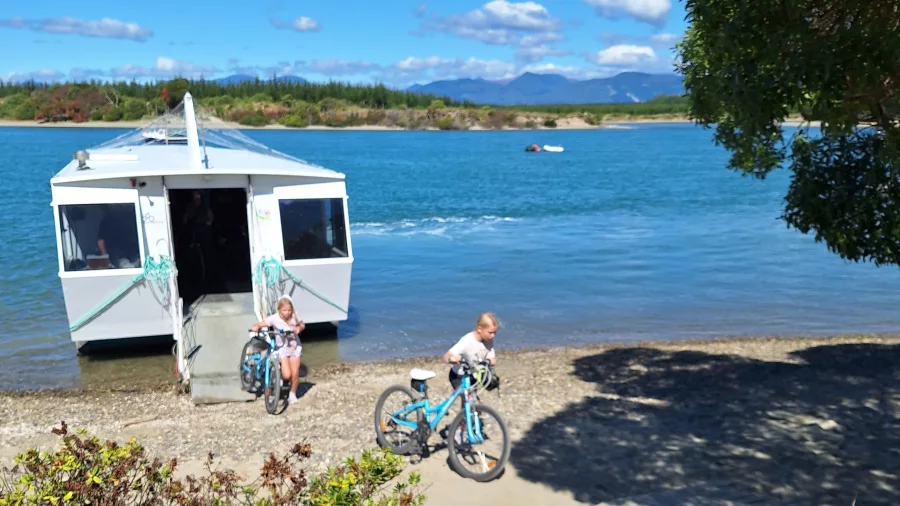 Children with bikes disembarking Mapua Ferry on Great Taste Trail