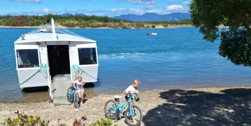 Children with bikes disembarking Mapua Ferry on Great Taste Trail