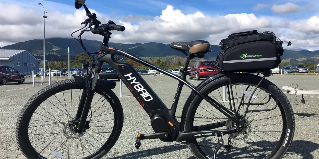 Premium hybrid carbon fibre e-bike with rear carrier case available at Nelson Cycle Hire