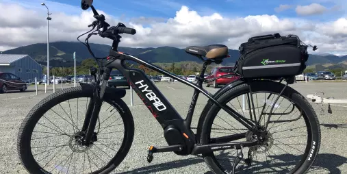 Premium hybrid carbon fibre e-bike with rear carrier case available at Nelson Cycle Hire