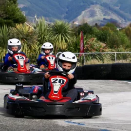 Children racing in fun karts on outdoor track at Pro Karts Nelson