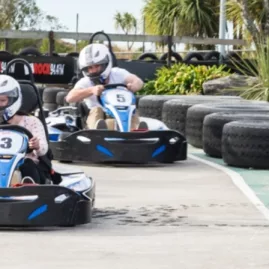 Family driving go karts on a track at Pro Karts Nelson