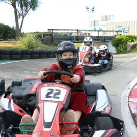 Child driving fun kart followed by two-seater go kart at Pro Karts Nelson