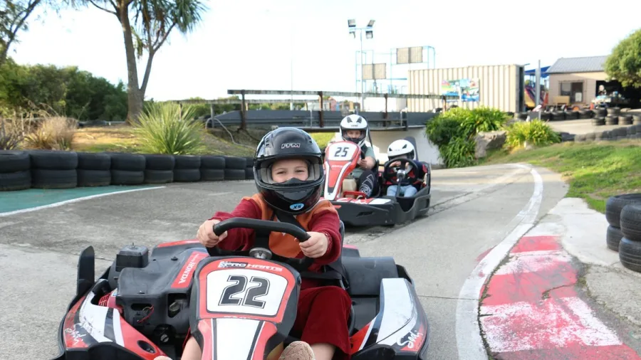 Child driving fun kart followed by two-seater go kart at Pro Karts Nelson
