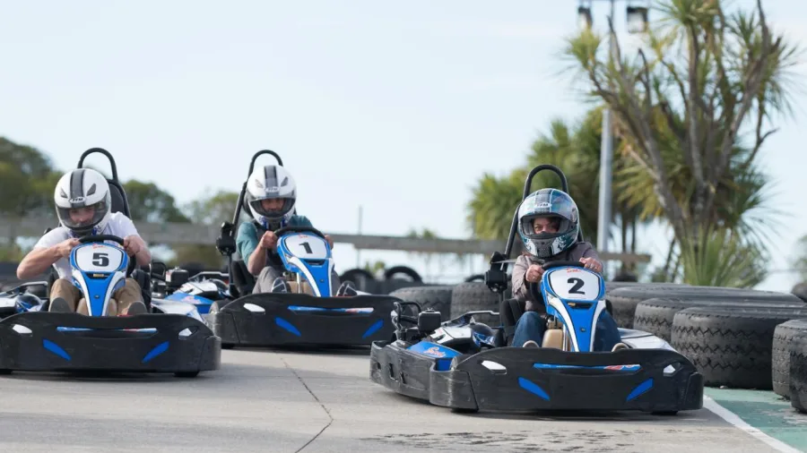 Three drivers racing go karts side by side on the Pro Karts track in Nelson