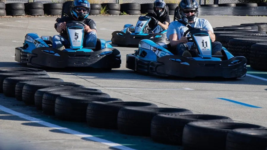Three go kart drivers racing around a corner at Pro Karts in Nelson