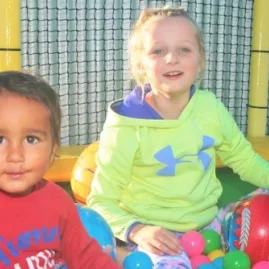 Two children playing in a trampoline park ball pit at Pro Karts in Nelson