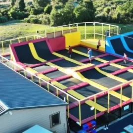 Aerial view of the outdoor trampoline park at Pro Karts in Nelson with multiple colourful jump zones