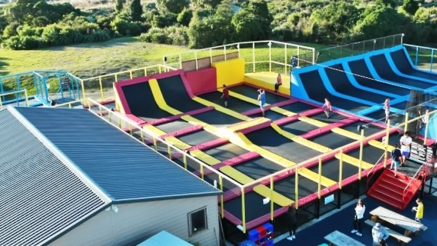 Aerial view of the outdoor trampoline park at Pro Karts in Nelson with multiple colourful jump zones