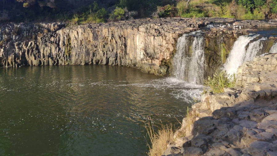 Haruru Falls cascading over a rocky cliff into the Waitangi River