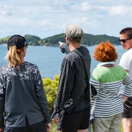 Group admiring the Bay of Islands during a scenic coastal walk
