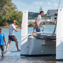 Travellers boarding a catamaran for a sailing trip in the Bay of Islands