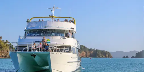 Discover the Bay Hole in the Rock Cruise vessel travelling through the turquoise waters of the Bay of Islands