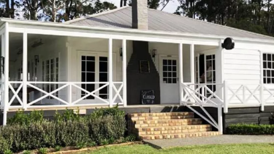 Historic Plough and Feather Pub with wraparound veranda and white weatherboard exterior in Kerikeri