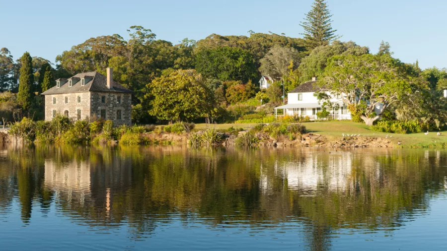 Stone Store and Kemp House reflected on the calm waters of Kerikeri Basin