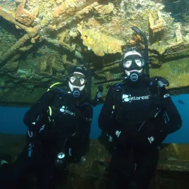 Two scuba divers exploring a shipwreck during advanced training in the Bay of Islands