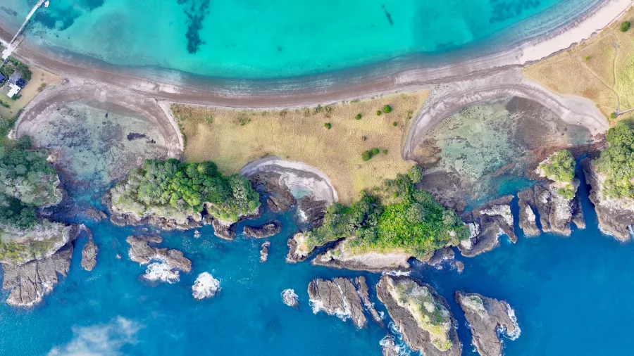 Aerial overview of Motuarohia Island and shoreline in the Bay of Islands