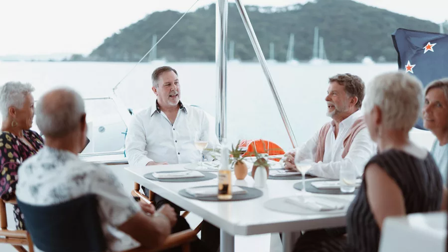 Group enjoying a lively conversation in the cockpit of a catamaran