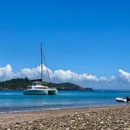 Catamaran anchored off South Waewaetorea Beach with clear skies and turquoise water