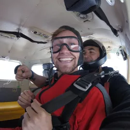 Kyle smiling inside the plane before tandem skydive over Bay of Islands