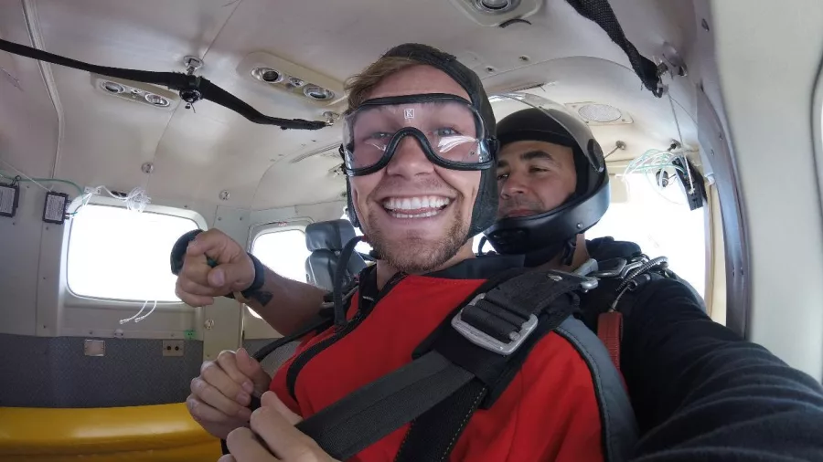 Kyle smiling inside the plane before tandem skydive over Bay of Islands