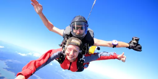 Tandem skydiving over Bay of Islands at 9000 feet on a clear blue day
