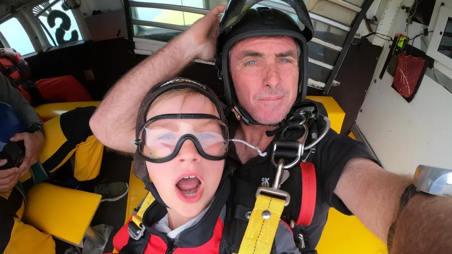 Tandem skydivers inside a plane with surprised expressions before jumping in the Bay of Islands