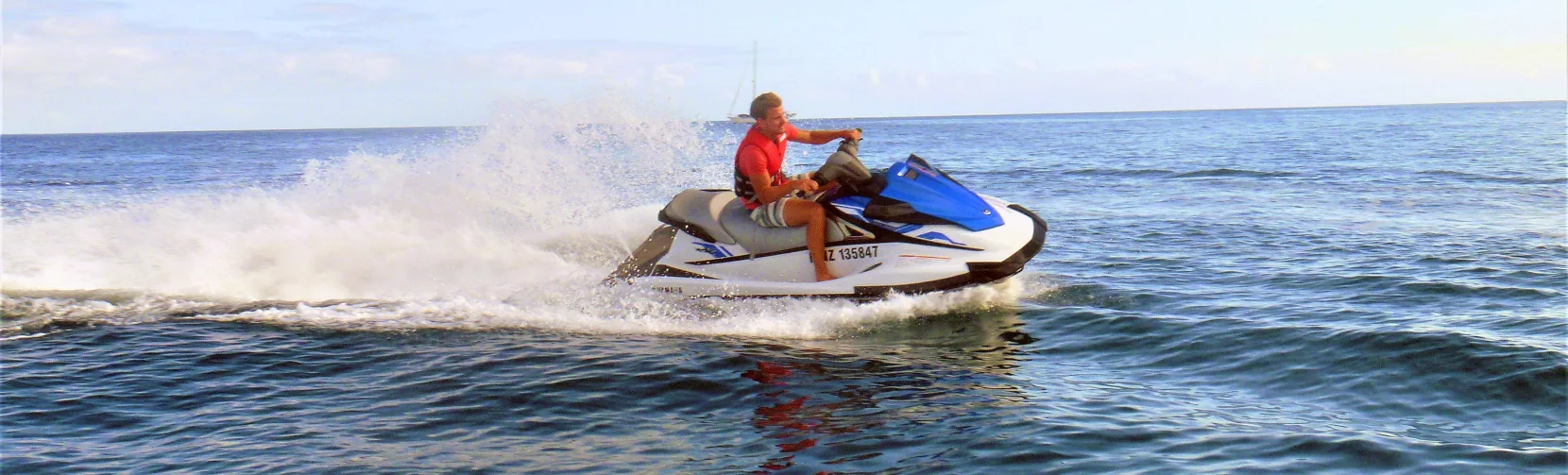 Person riding a jet ski on the ocean during a Tango Jet Ski tour in the Bay of Islands