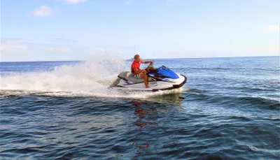 Person riding a jet ski on the ocean during a Tango Jet Ski tour in the Bay of Islands