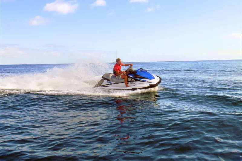 Person riding a jet ski on the ocean during a Tango Jet Ski tour in the Bay of Islands