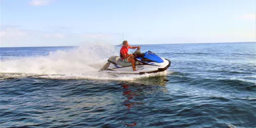 Person riding a jet ski on the ocean during a Tango Jet Ski tour in the Bay of Islands