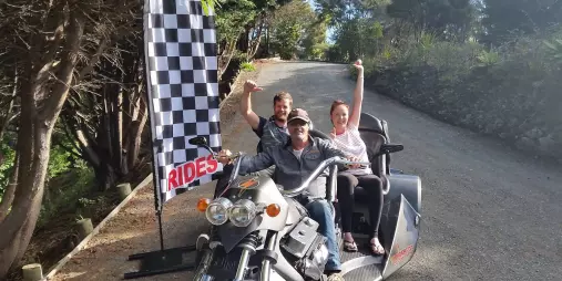Riders posing on a Thunder Trike before starting their Bay Combo experience