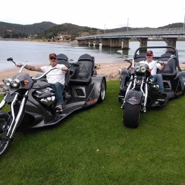 Thunder Trike tour guides posing on custom bikes by the waterfront in Paihia, Bay of Islands