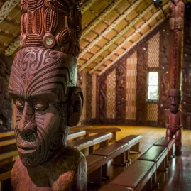 Intricately carved wooden figure inside a Māori meeting house at Waitangi Treaty Grounds, Northland, New Zealand