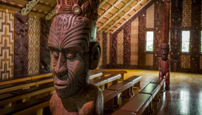 Intricately carved wooden figure inside a Māori meeting house at Waitangi Treaty Grounds, Northland, New Zealand