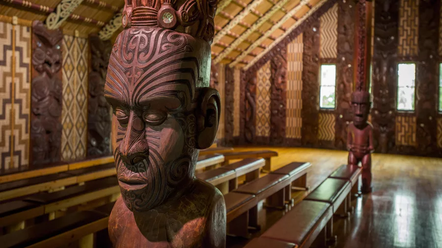Intricately carved wooden figure inside a Māori meeting house at Waitangi Treaty Grounds, Northland, New Zealand