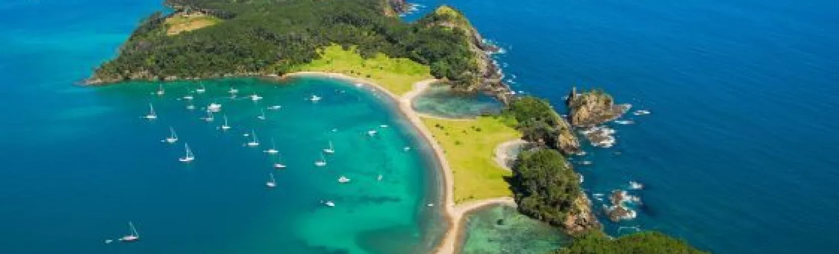 Aerial view of Roberton Island (Motuarohia) with anchored yachts in the Bay of Islands