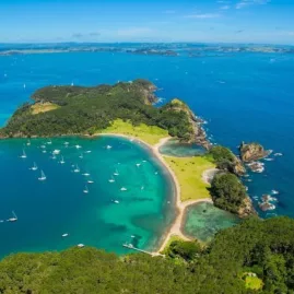 Aerial view of Roberton Island (Motuarohia) with anchored yachts in the Bay of Islands