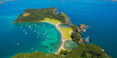 Aerial view of Roberton Island (Motuarohia) with anchored yachts in the Bay of Islands