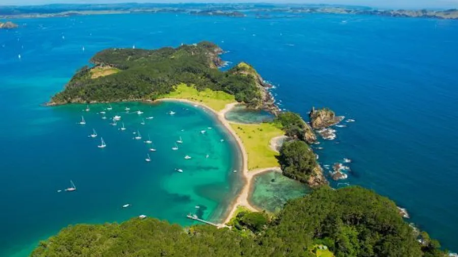 Aerial view of Roberton Island (Motuarohia) with anchored yachts in the Bay of Islands