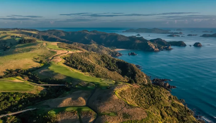Aerial view of Kauri Cliffs Golf Course with sweeping vistas over the Bay of Islands and offshore islands, New Zealand
